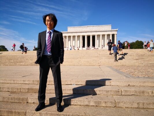 a person standing on steps in front of a building