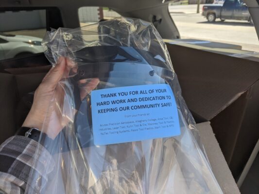 a hand holding a plastic bag with a blue label