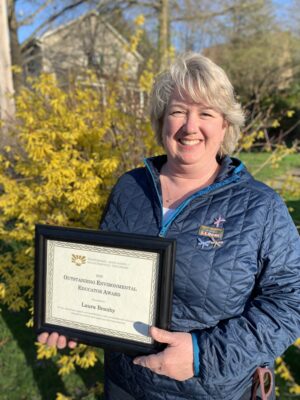 a person holding a framed certificate