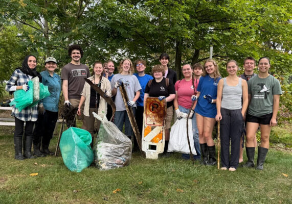 Group of students outside collecting trash
