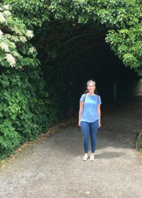 a person standing on a path with trees