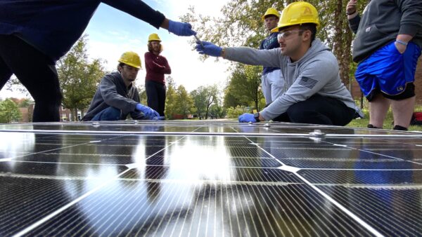 Students building a solar panel