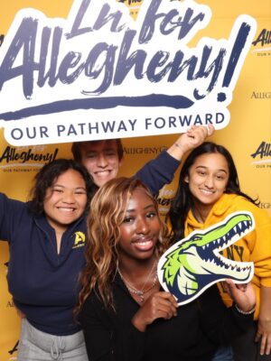 Allegheny College students, faculty, and staff pose with signage for "In for Allegheny", the largest capital campaign in Allegheny history