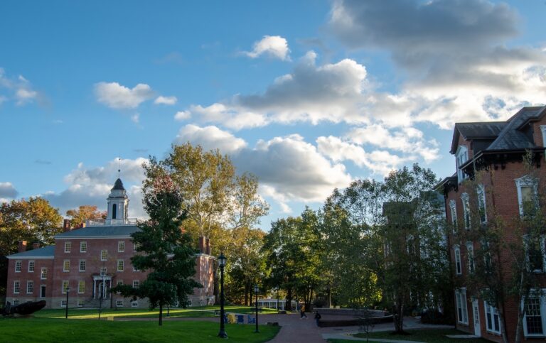 Red brick neoclassical buildings surrounded by trees on Allegheny College's campus
