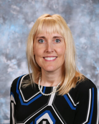 portrait of a person with blonde hair wearing a black and blue dress