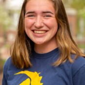 Smiling woman with long hair parted in middle