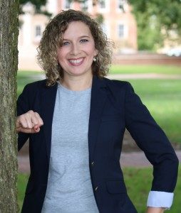 portrait of a person standing next to a tree