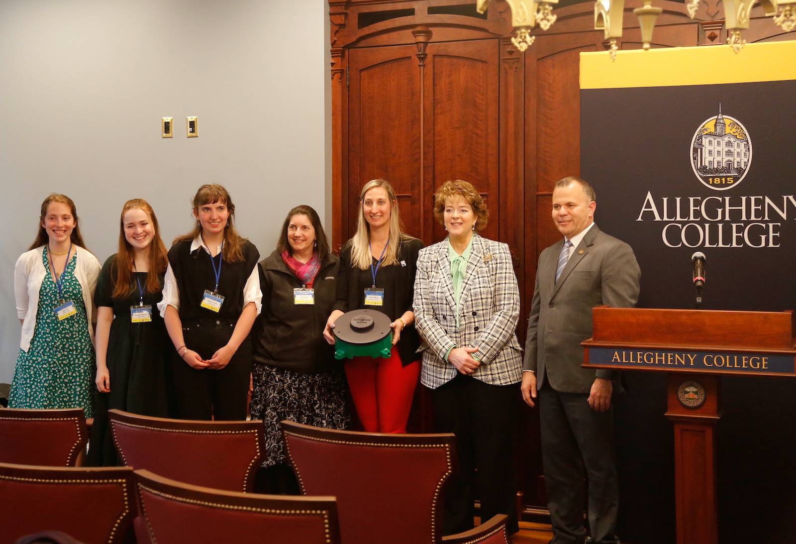 seven individuals post for a photo at tick mitigation project press conference at Allegheny College