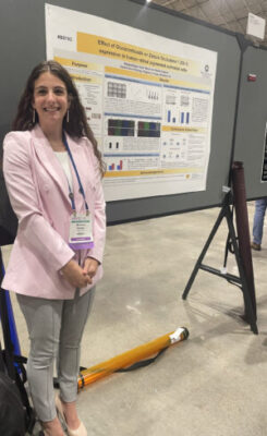 a person standing in front of a research poster