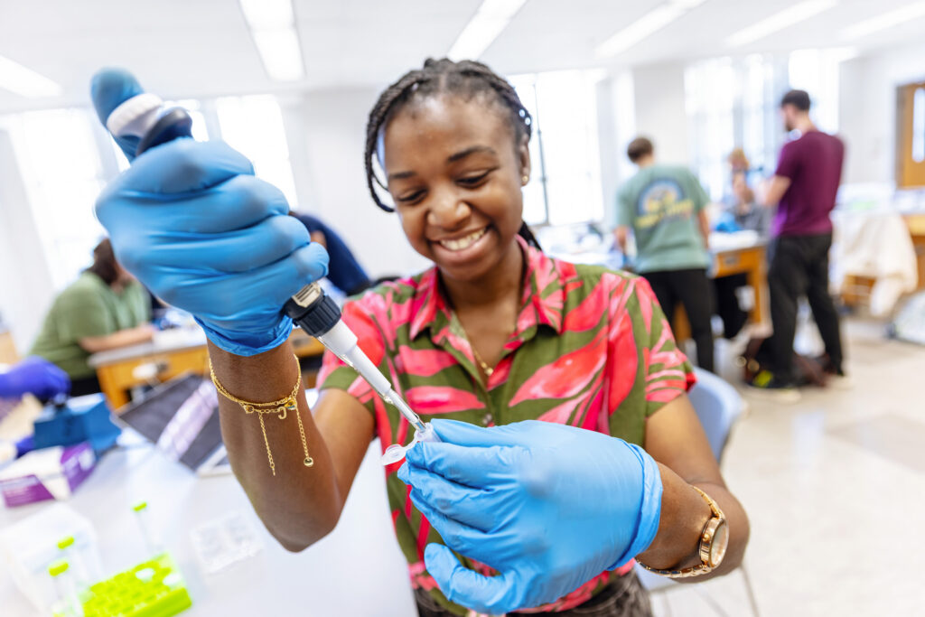 Student in a lab with a pipette