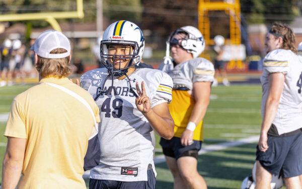 Football player giving a peace hand sign