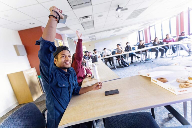 Students raising their hand in classroom