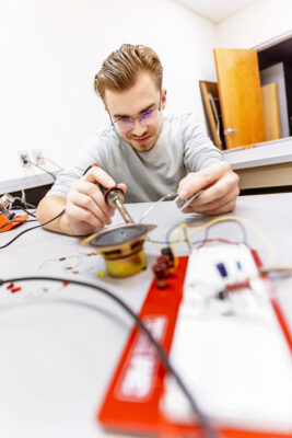 Student in a lab testing an electrical device