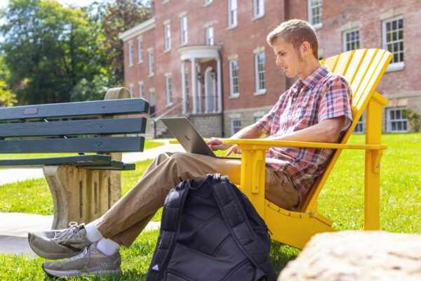 Student on their laptop outside
