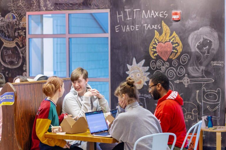 Students around a table in a dining hall