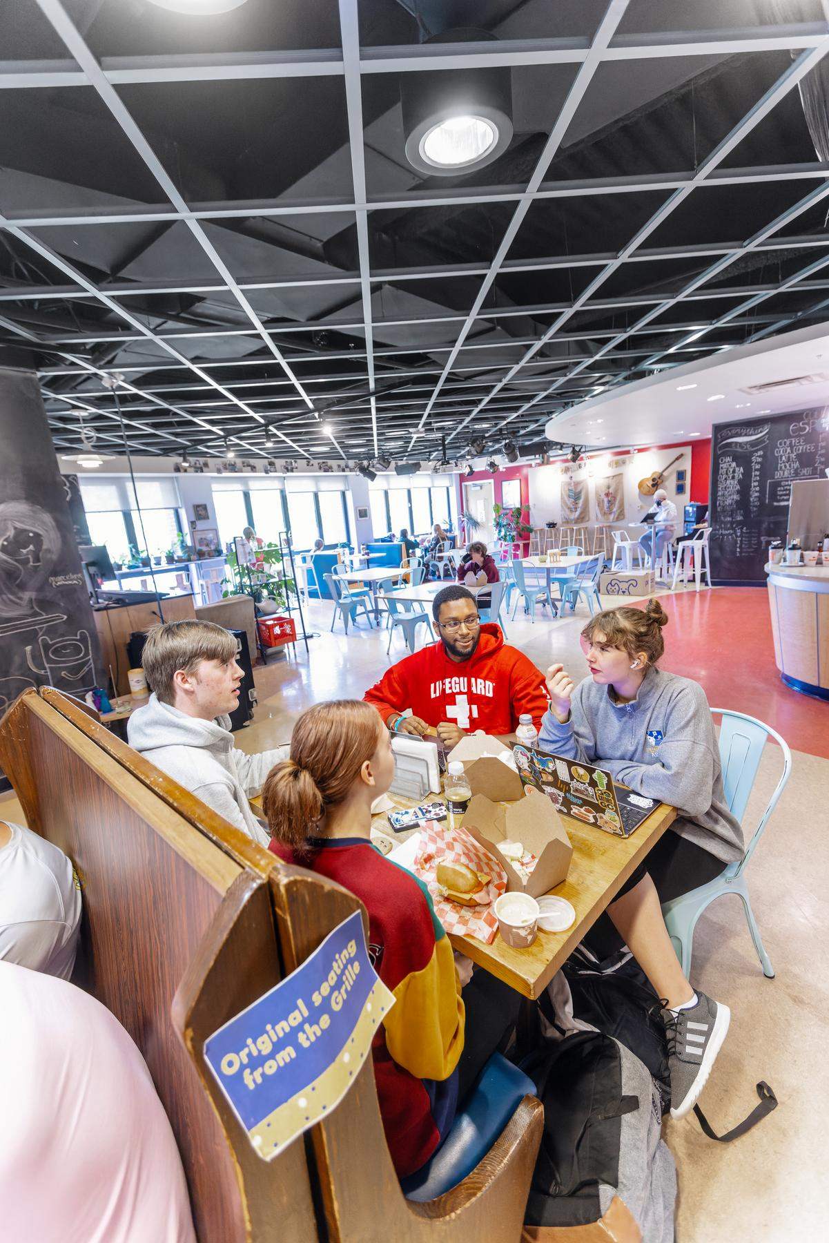 a group of students sitting at a dining table