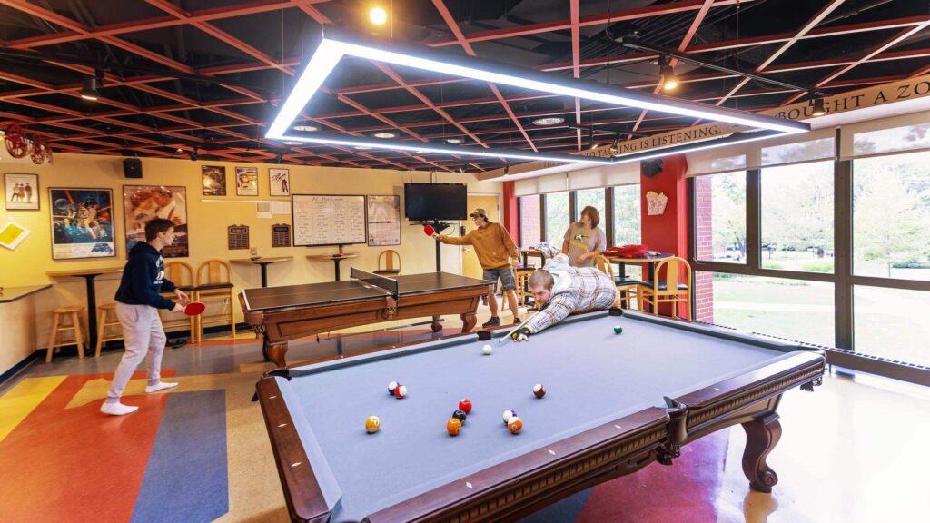 Students playing pool in the game room