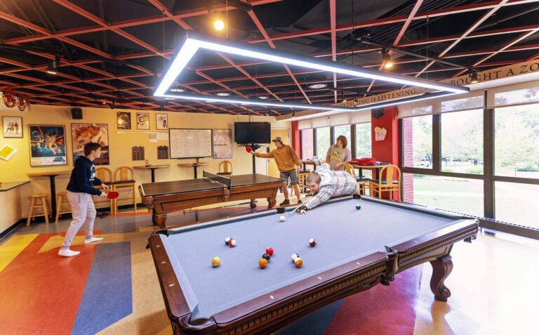 Students playing pool in the game room