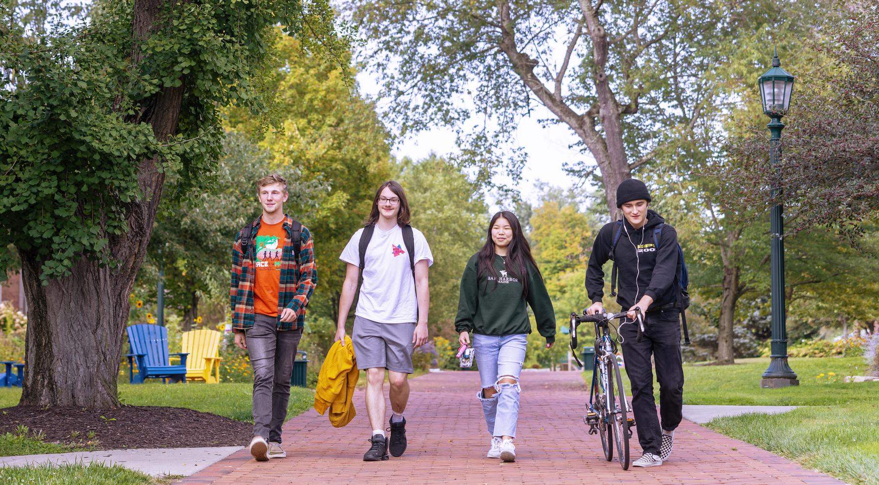 Four students walking on campus