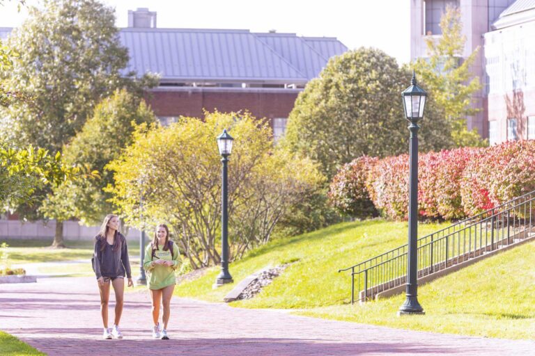 Two female students walking on campus