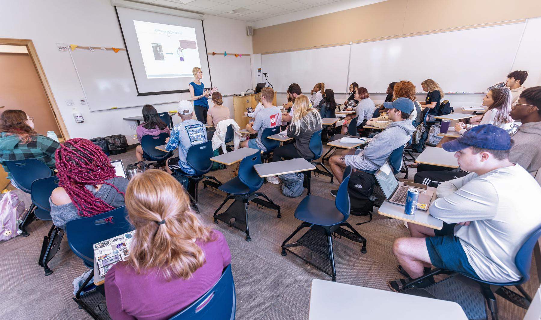 a group of students seated at desks in a classroom