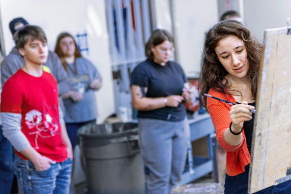 Faculty member teaching a painting class
