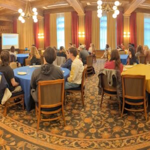 a group of people sitting at banquet tables in a room