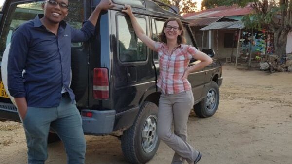 People standing at the back of a car