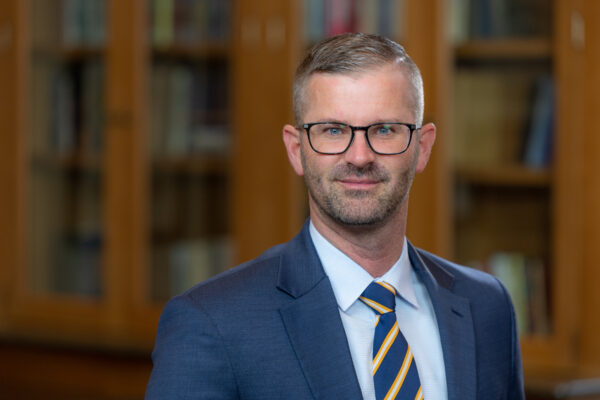 posed headshot of Andy Walker in suit and tie