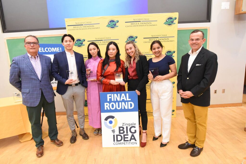 a group of people standing in front of a sign