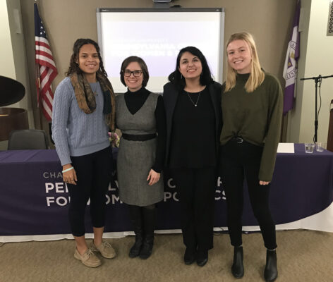 a group of women standing in front of a white board