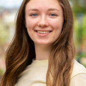 Smiling woman with long straight hair outdoors