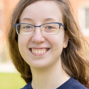 Person with glasses and navy blue t shirt