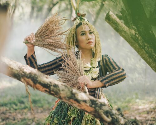 Peni Candra Rini poses in Java — the most populous island of Indonesia. The stalks of rice she wears and holds are Javanese cultural symbols.