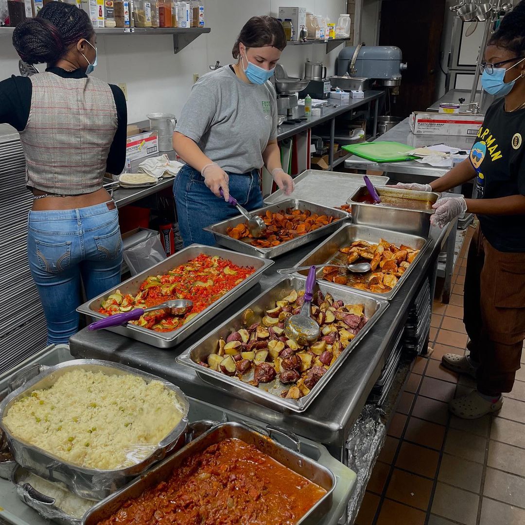 Photo of students collecting food in a kitchen