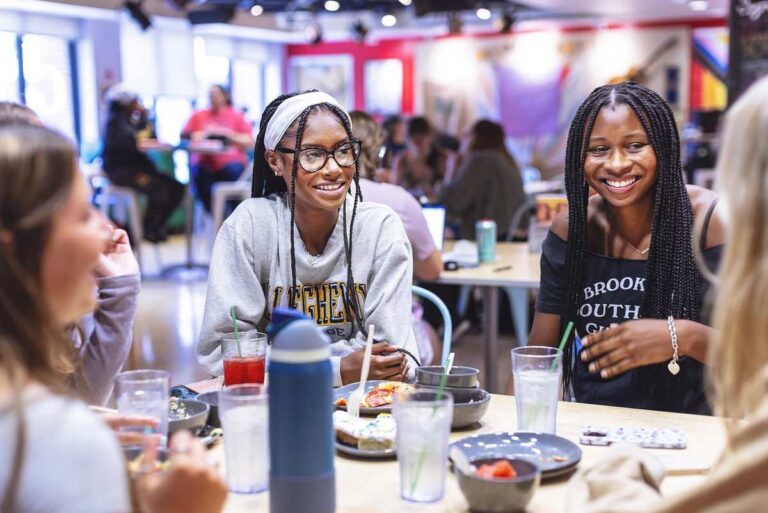 Three female students sitting at café table.