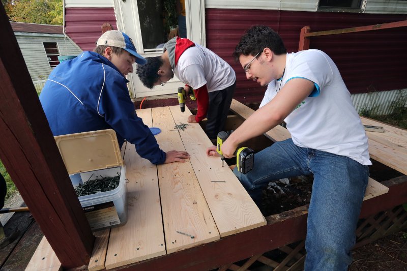 Student working on a carpentry project outside.