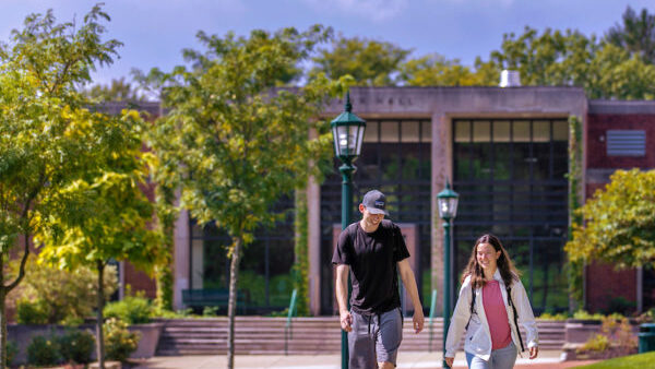 Two students walking on campus.