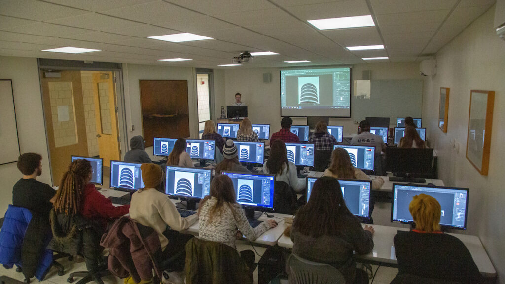 a group of students sitting in a computer lab
