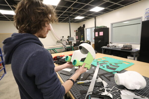 student working in a lab with hands-on materials