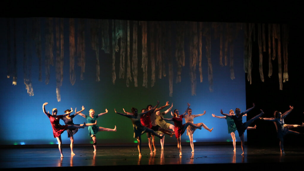 a group of people dancing on stage