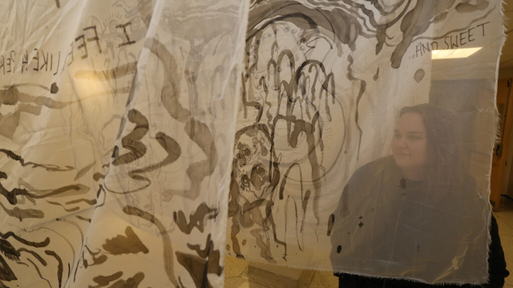 a person standing behind a transparent sheet