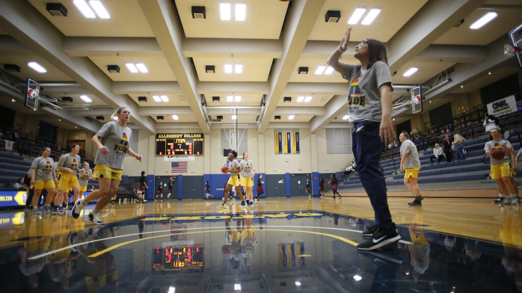 a group of students playing basketball indoors