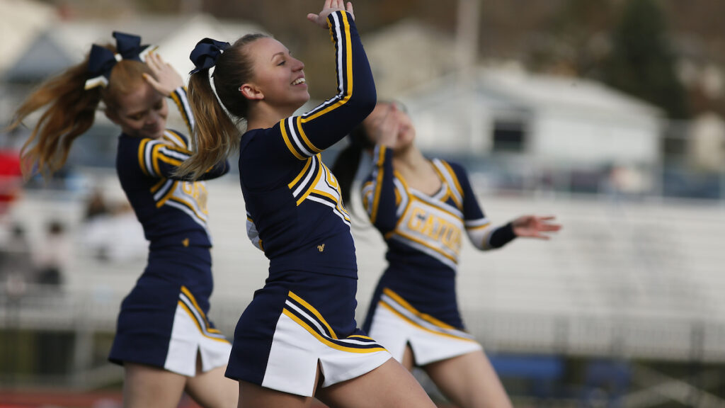 a group of cheerleaders dancing on a field