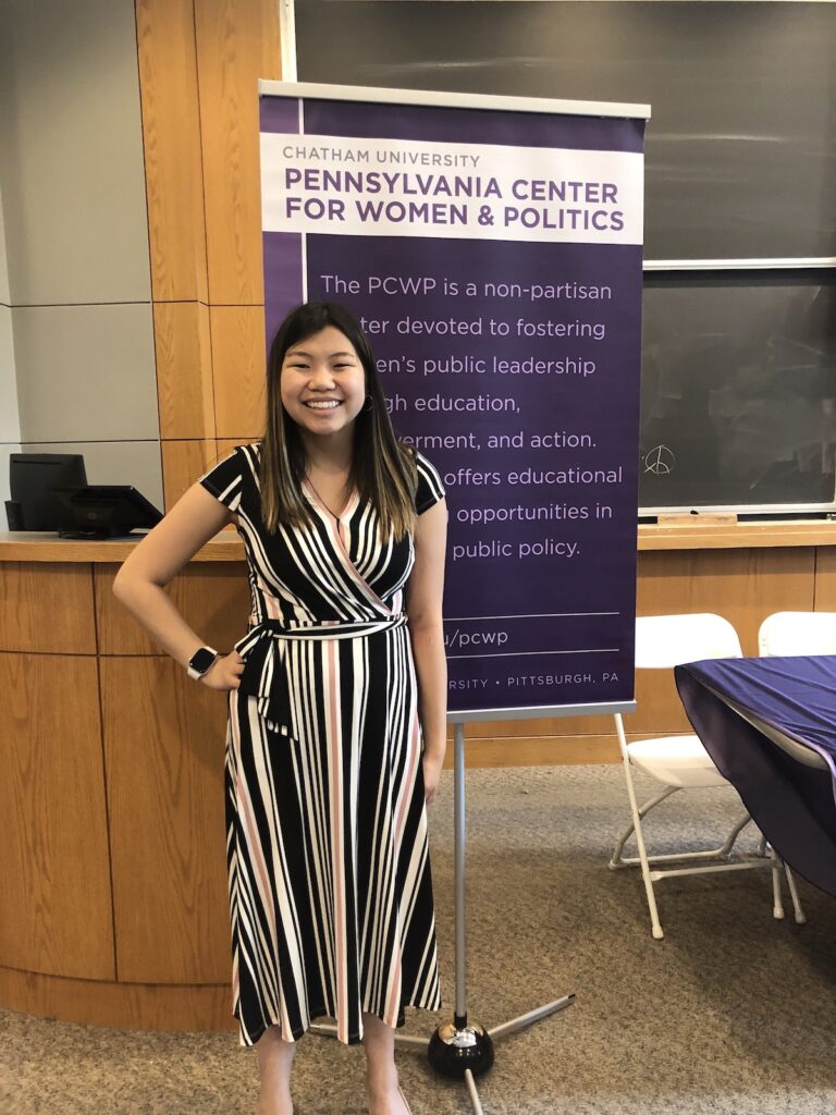 a person standing in front of a research poster