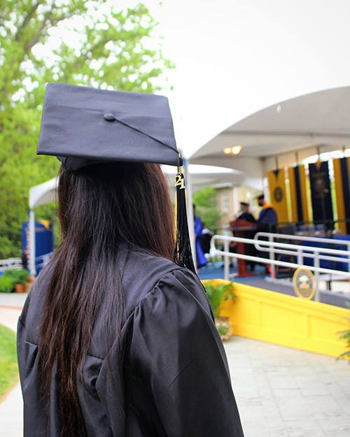 a person wearing a graduation cap and gown