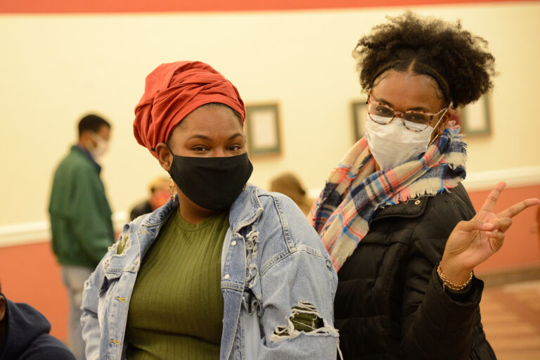 a couple of women wearing face masks