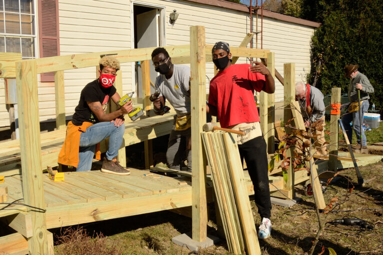 a group of students building a deck