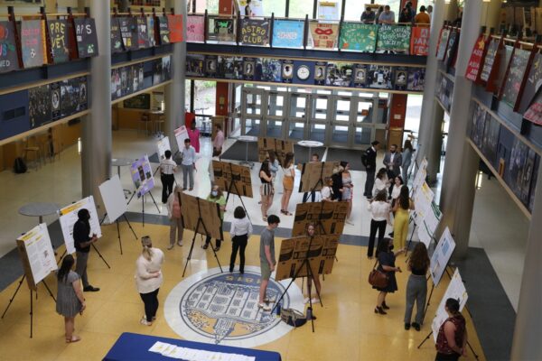 students viewing a symposium display