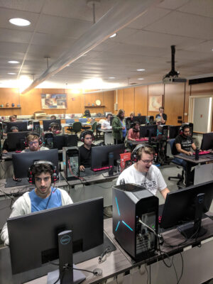 a group of people sitting in a room with computers